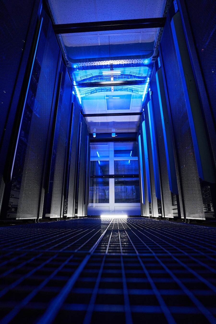 Close up image of modern interior of server racks with storage information with blue neon in data center